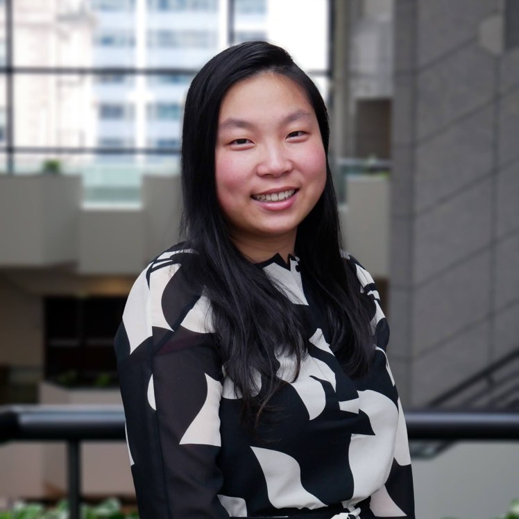 Asian female in a grey blazer smiling