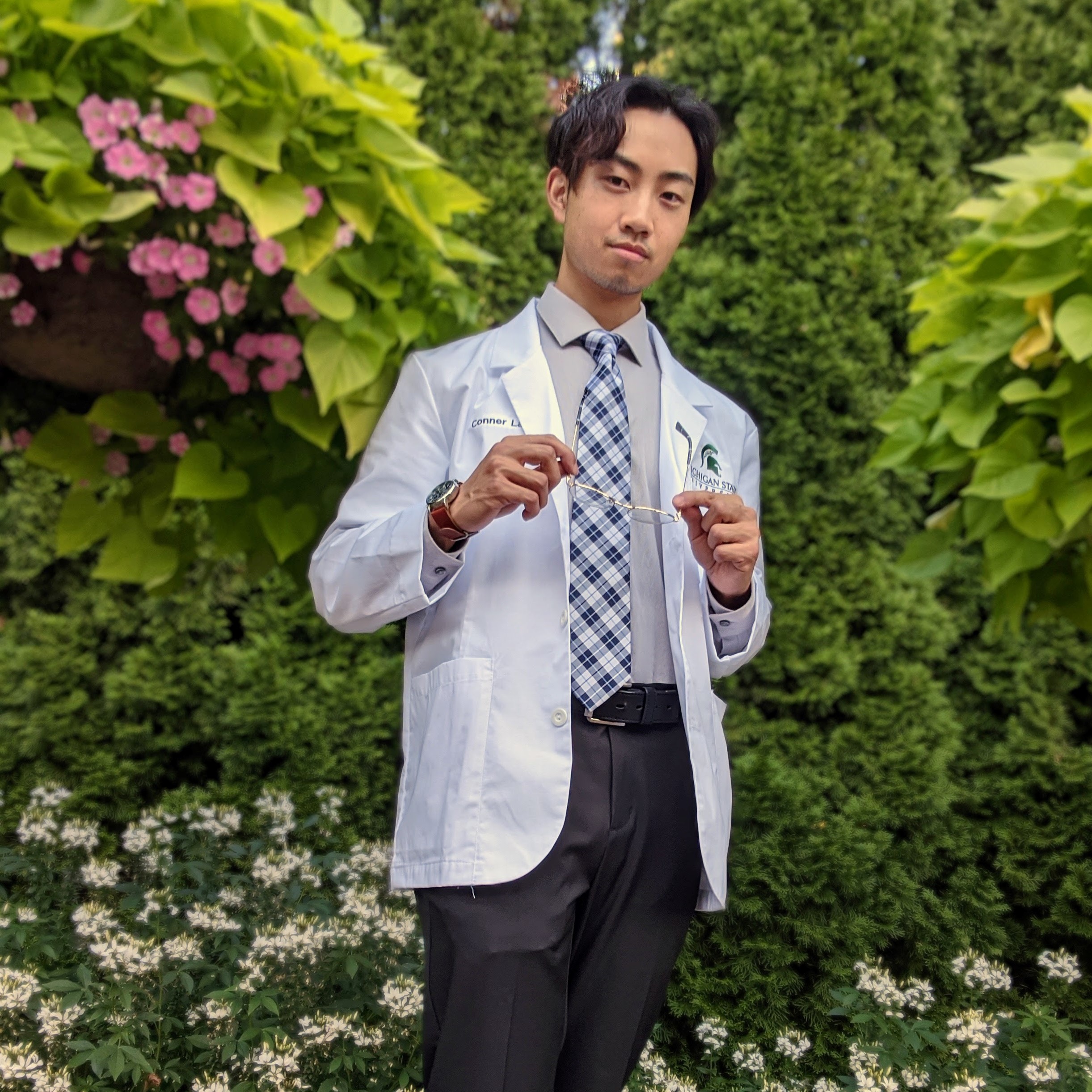 Asian male smiling in doctor's coat